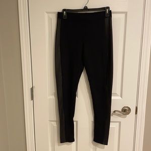 Women’s black leggings with leather down side.